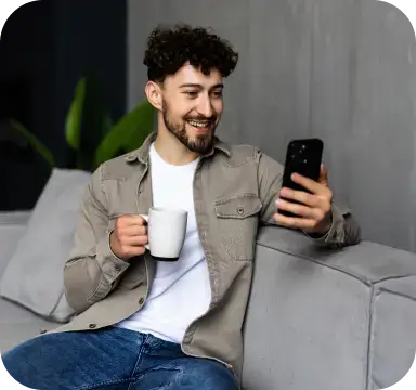 Man with cup and phone in his hands